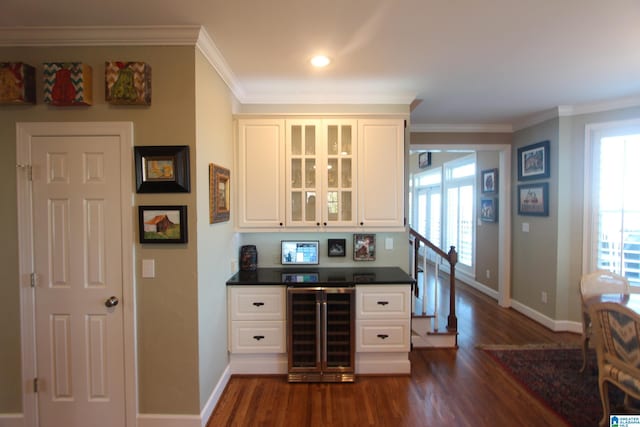 bar featuring white cabinets, dark hardwood / wood-style floors, ornamental molding, and wine cooler