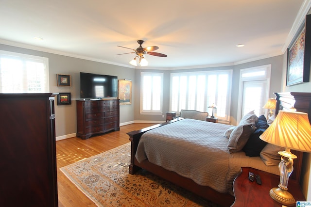 bedroom featuring ceiling fan, ornamental molding, and light hardwood / wood-style flooring