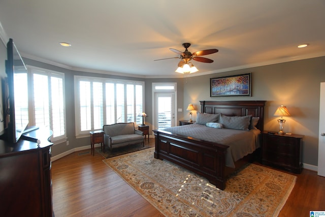 bedroom with hardwood / wood-style floors, ceiling fan, and ornamental molding