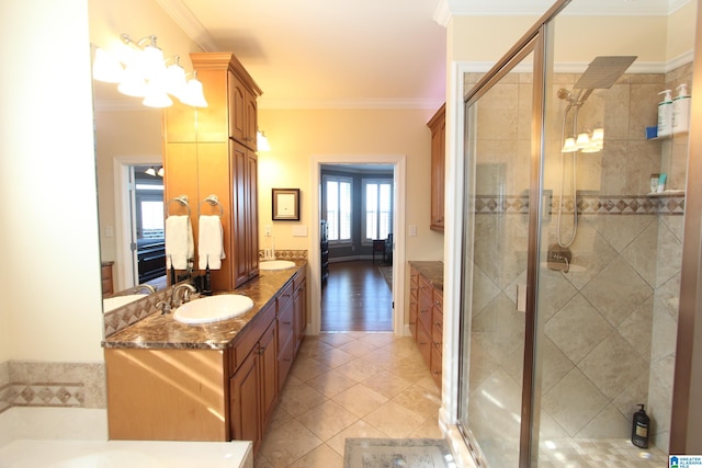 bathroom featuring tile patterned flooring, vanity, a shower with door, and ornamental molding