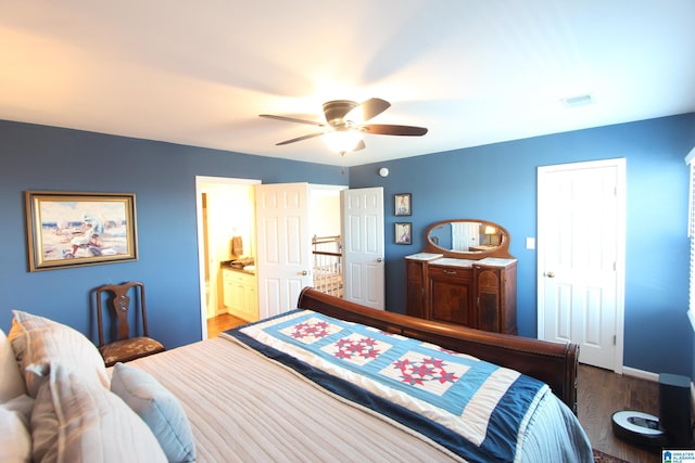 bedroom featuring hardwood / wood-style floors, ceiling fan, and ensuite bath