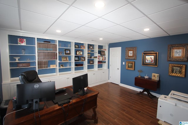 home office featuring built in shelves and dark wood-type flooring