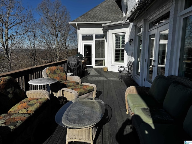 wooden terrace with french doors, an outdoor living space, and area for grilling