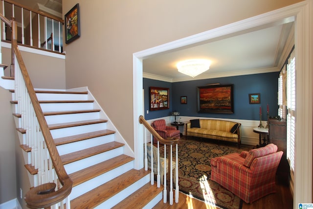 stairs featuring hardwood / wood-style floors and crown molding