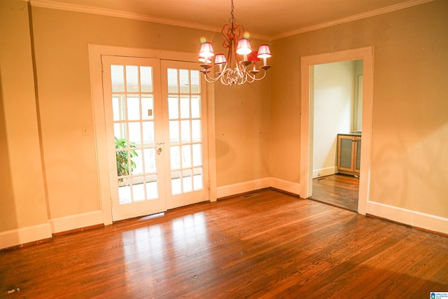 unfurnished dining area featuring wood-type flooring, crown molding, french doors, and a notable chandelier