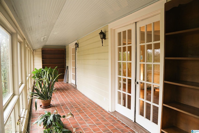 unfurnished sunroom featuring a healthy amount of sunlight and wood ceiling