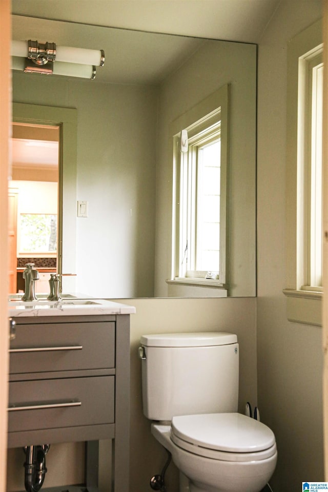 bathroom featuring vanity and toilet