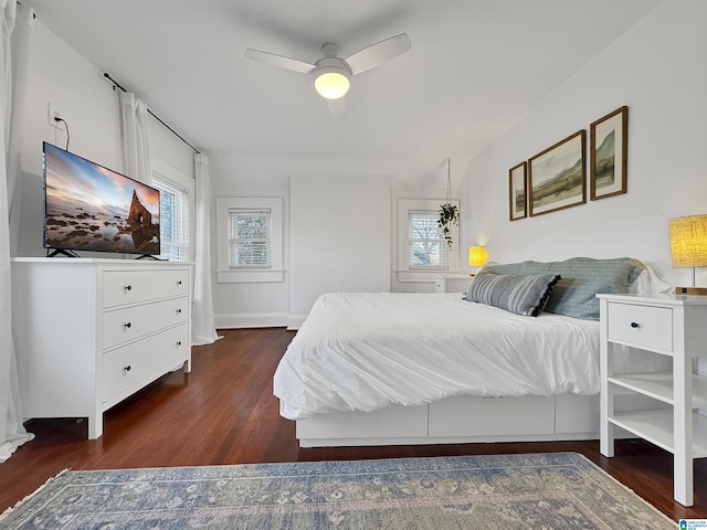 bedroom with ceiling fan and dark hardwood / wood-style flooring