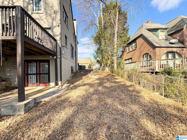 view of home's exterior with a wooden deck