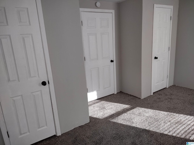 unfurnished bedroom featuring dark colored carpet