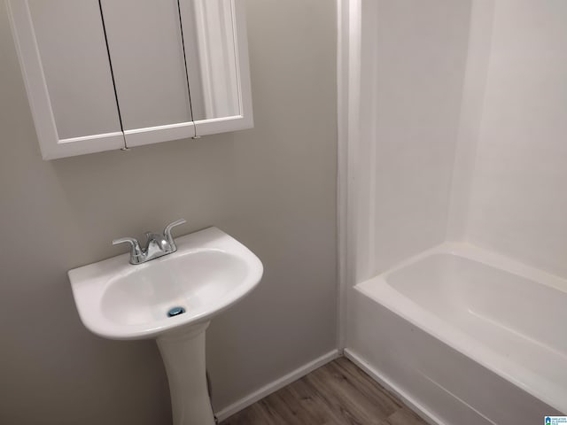 bathroom featuring a tub and hardwood / wood-style flooring