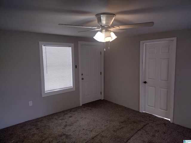 empty room with ceiling fan and carpet