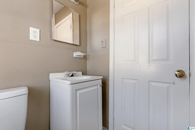 bathroom with toilet and vanity