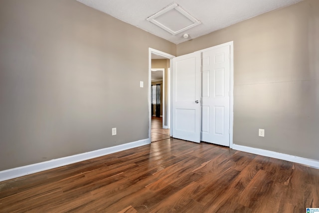 unfurnished bedroom with dark wood-type flooring