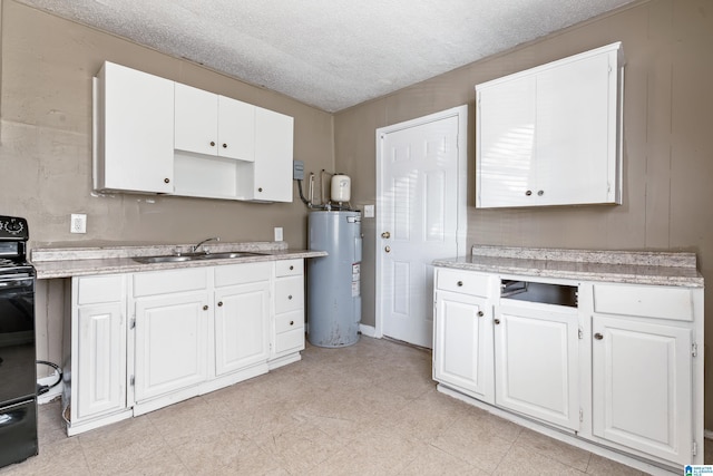 kitchen featuring white cabinets, water heater, sink, and a textured ceiling