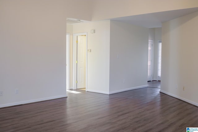 empty room with dark wood-type flooring