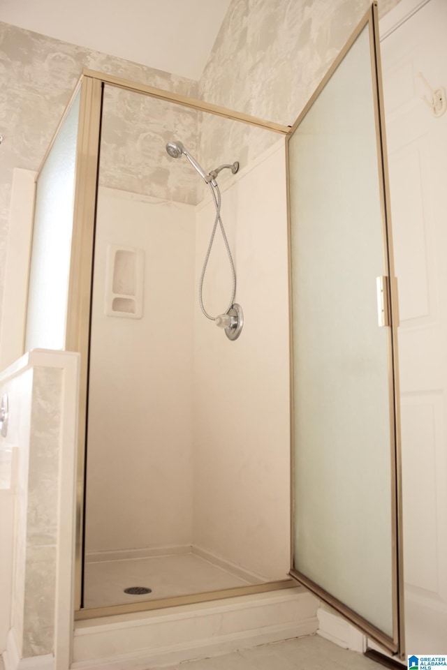 bathroom with a shower with shower door