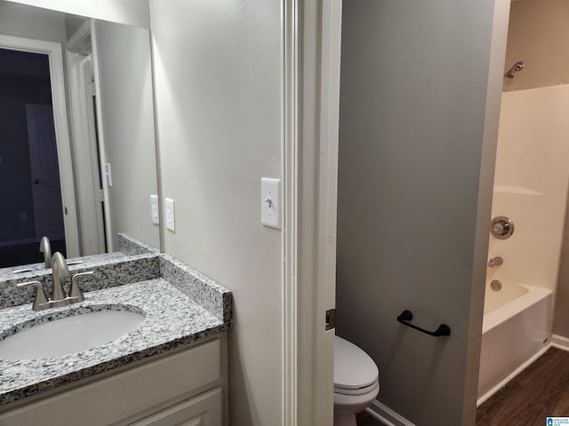 full bathroom featuring toilet, shower / bathtub combination, wood-type flooring, and vanity