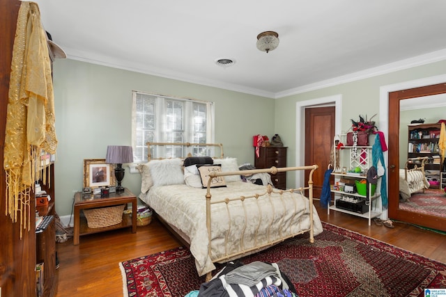 bedroom featuring dark hardwood / wood-style flooring and ornamental molding