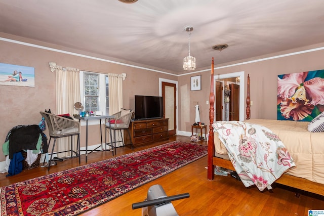 bedroom featuring hardwood / wood-style flooring and crown molding