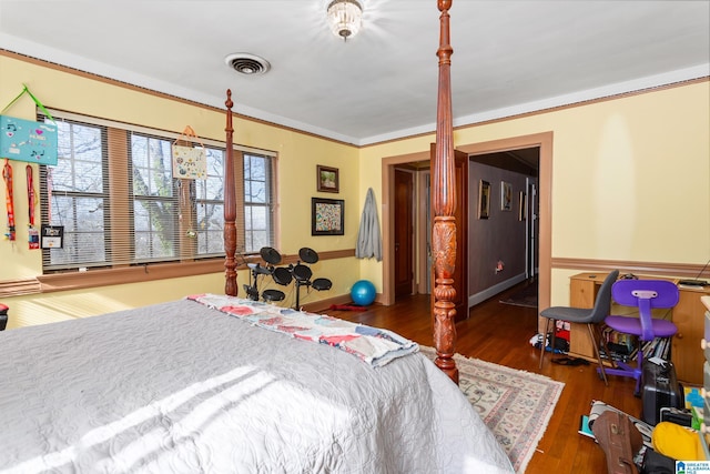 bedroom with dark hardwood / wood-style flooring and crown molding