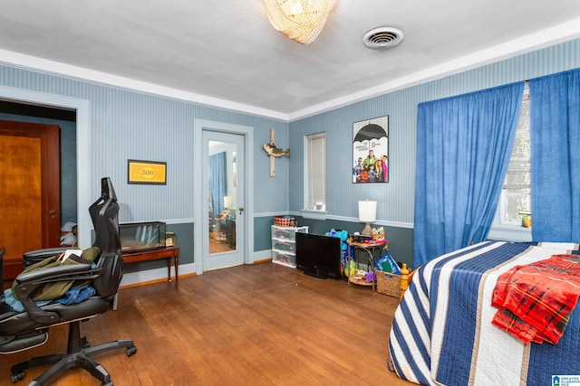 bedroom featuring crown molding and hardwood / wood-style floors