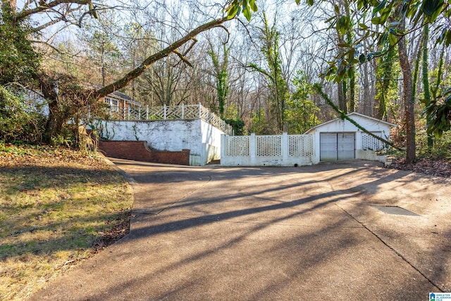 view of gate featuring an outbuilding