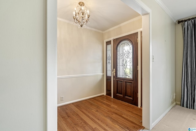 entrance foyer with ornamental molding, hardwood / wood-style flooring, and a notable chandelier