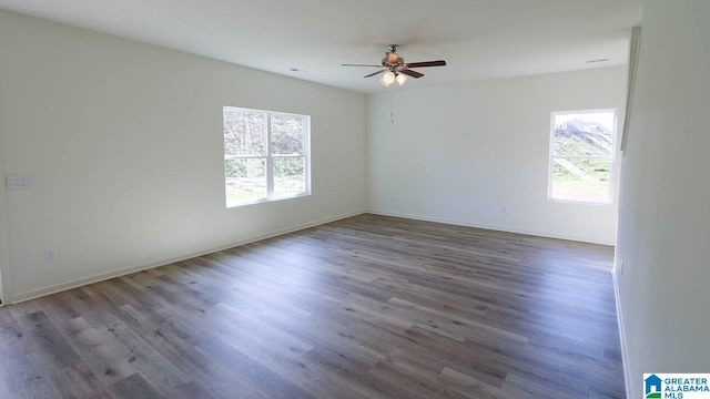 unfurnished room with ceiling fan and wood-type flooring