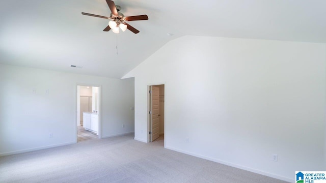 carpeted empty room featuring ceiling fan and vaulted ceiling