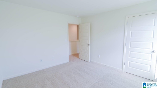 unfurnished bedroom with light carpet