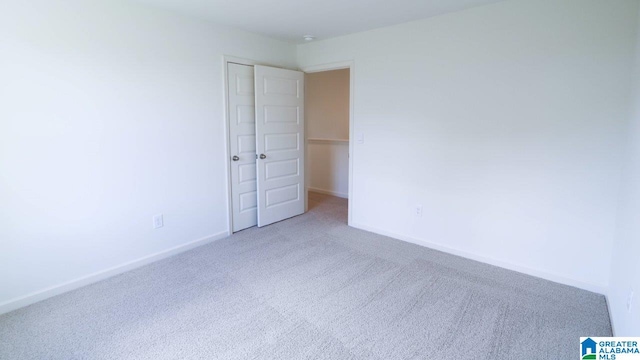 unfurnished bedroom with carpet floors and a closet