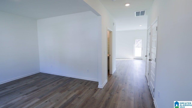 corridor featuring dark wood-type flooring