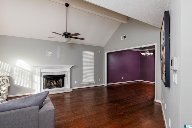 living room featuring ceiling fan with notable chandelier, a textured ceiling, a high end fireplace, vaulted ceiling with beams, and hardwood / wood-style flooring