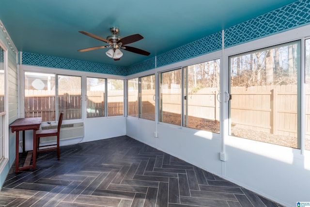 unfurnished sunroom featuring ceiling fan