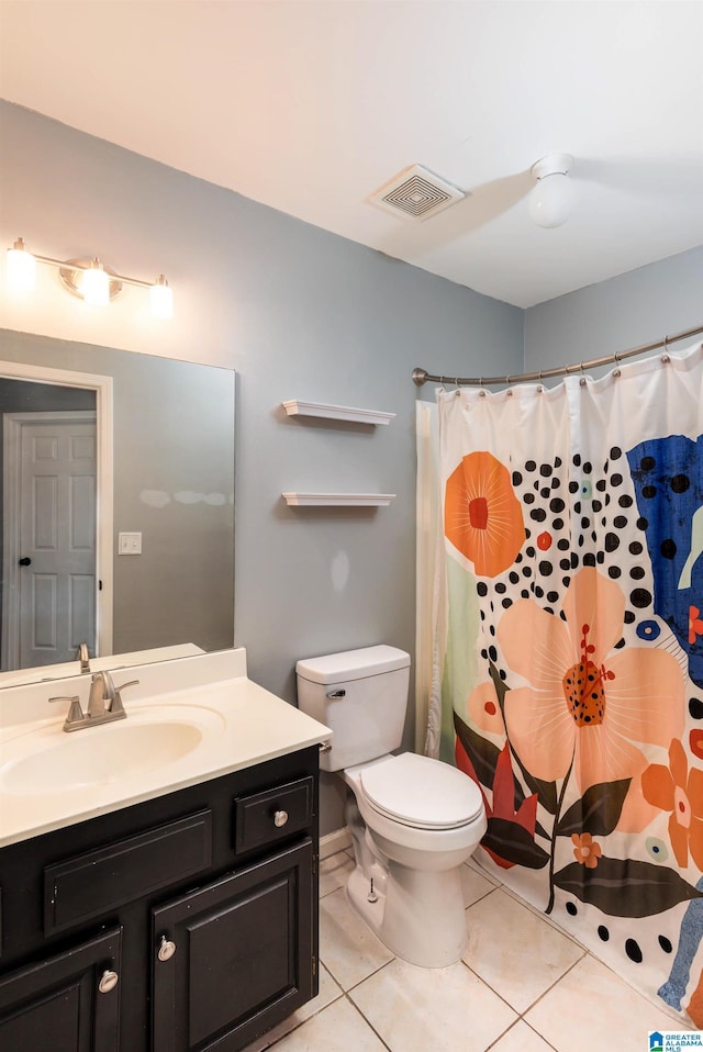 bathroom featuring toilet, walk in shower, tile patterned floors, and vanity