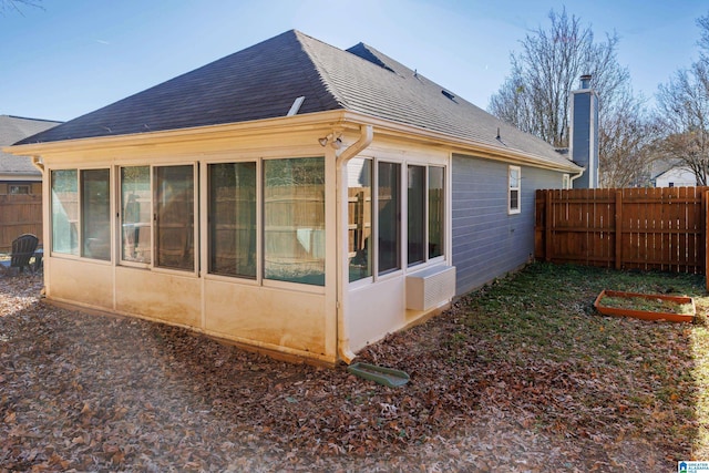 view of property exterior featuring a sunroom