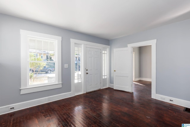 entryway with dark hardwood / wood-style flooring