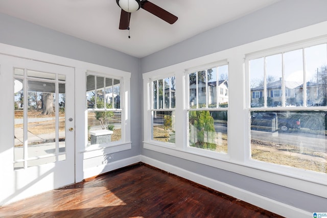 unfurnished sunroom featuring plenty of natural light and ceiling fan