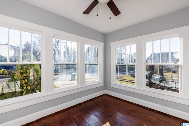 unfurnished sunroom with ceiling fan