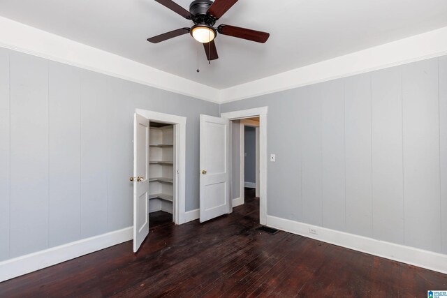 unfurnished bedroom with dark hardwood / wood-style floors and ceiling fan