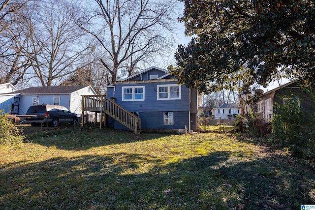 rear view of property featuring a yard