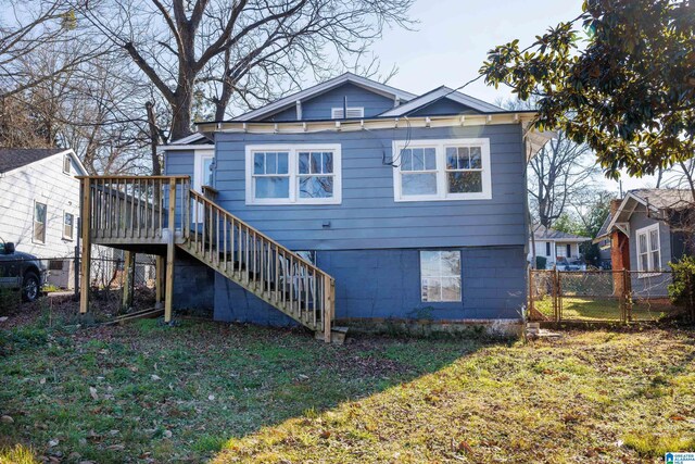 back of house with a lawn and a wooden deck