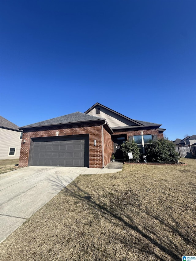 ranch-style house featuring a front yard and a garage