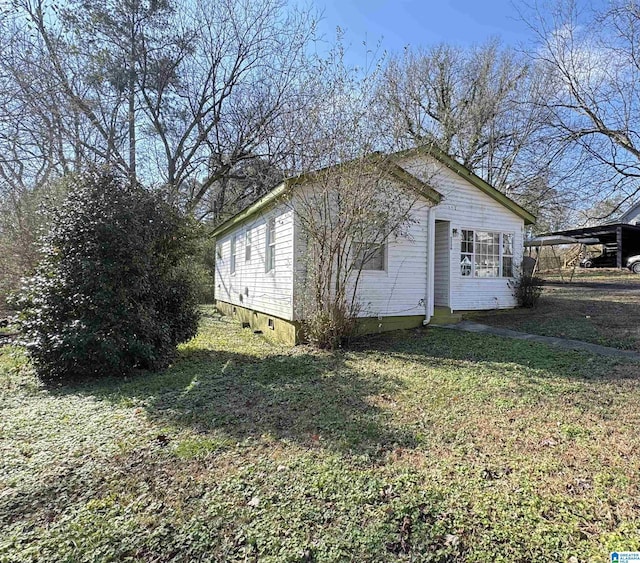 view of side of home with a yard