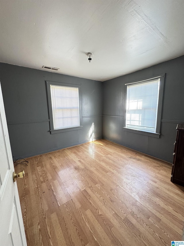 spare room featuring light hardwood / wood-style floors