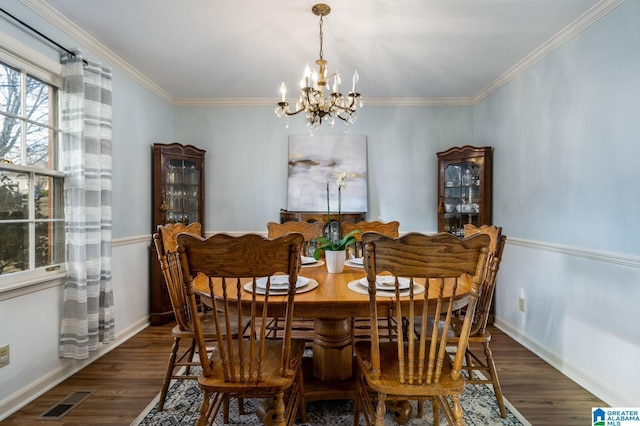 dining area with crown molding, dark hardwood / wood-style floors, and a notable chandelier