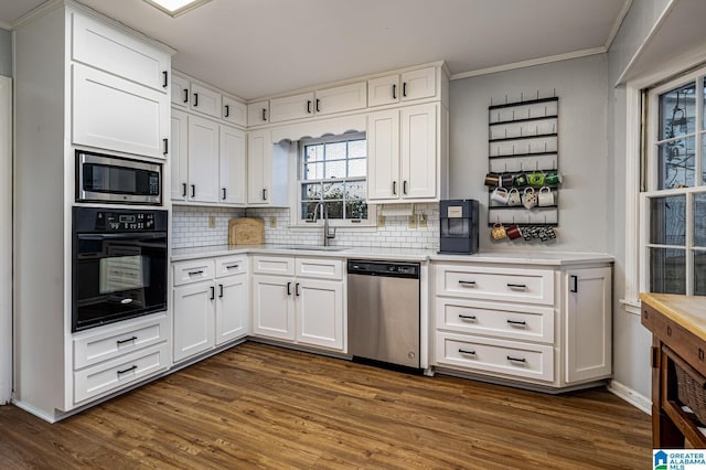 kitchen with white cabinets, appliances with stainless steel finishes, dark wood-type flooring, and sink