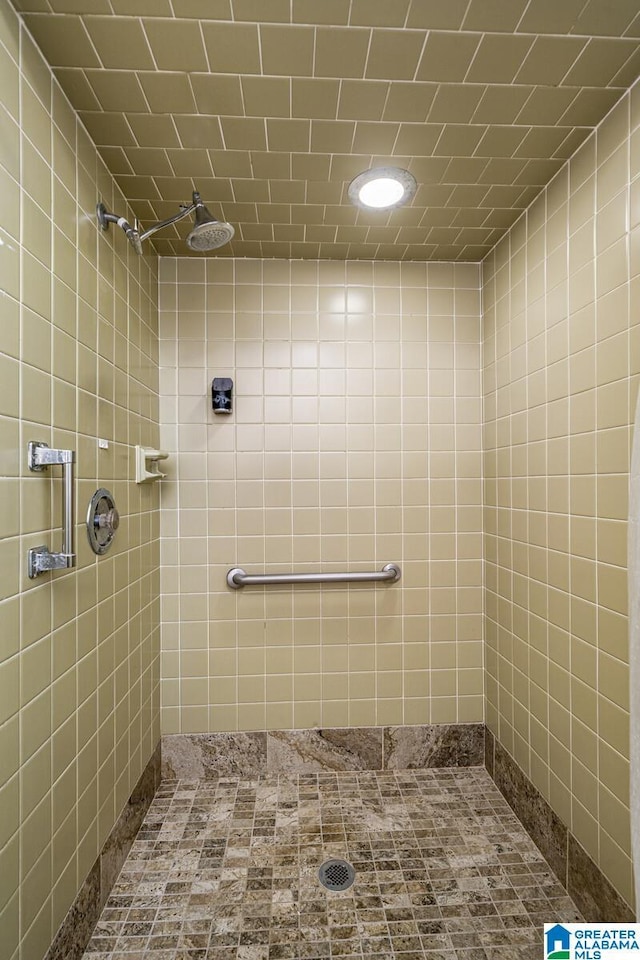 bathroom with a tile shower