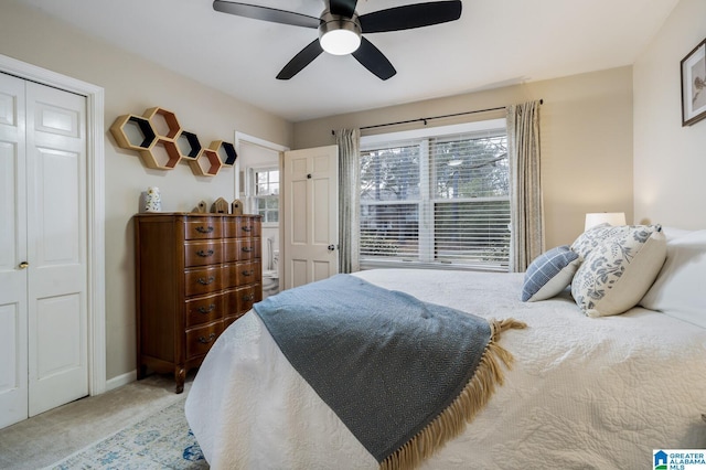 carpeted bedroom featuring a closet and ceiling fan